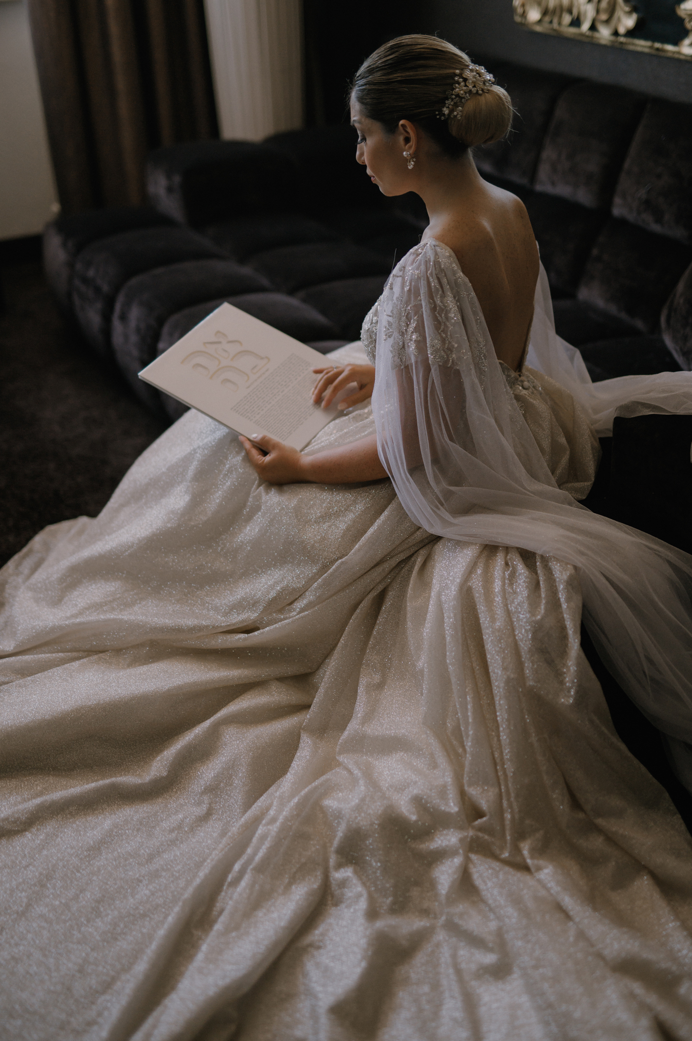A bride holding her customized Ketubah, showing the intricate details.